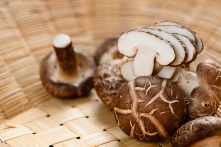 Shiitake mushrooms (Lentinus edodes) on the wooden background.