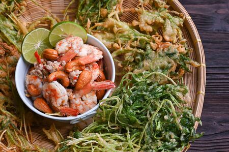 Crispy deep fried morning glory with spicy shrimp salad. wood backgroundの写真素材