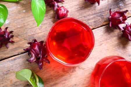 Roselle juice on wooden background, herbal organic tea for good healthy and refreshment.の写真素材