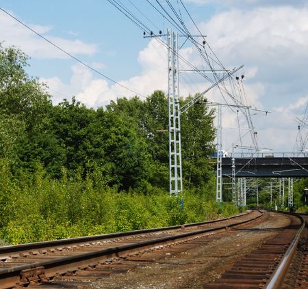 Railroud with forest around and bridge above.の写真素材