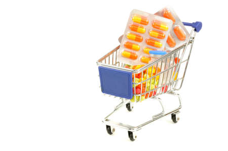 Shopping cart with medecine pills on a white backgroundの写真素材