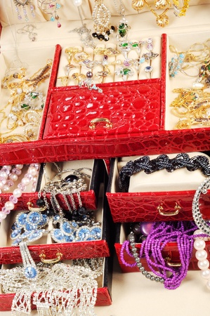 An open jewlery box with gold and platinum  jewelry and accessory on a white backgroundの写真素材