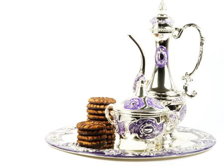 Chocolate cookies serve with metal tea set  on a white backgroundの写真素材