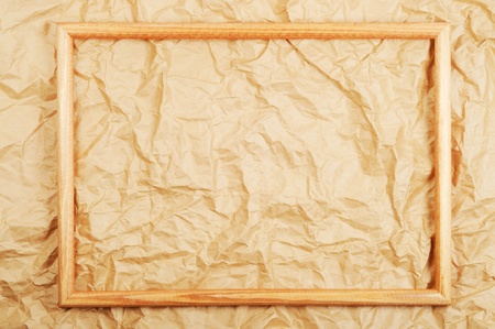 Wooden frame on old crumbled paperの写真素材