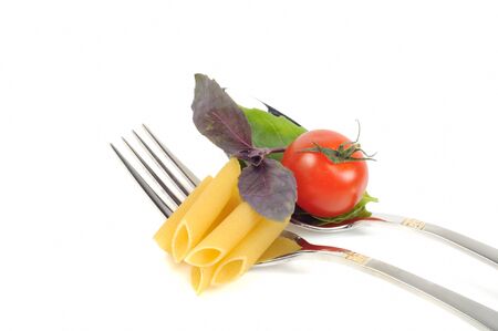 Cooking concept,four forks with tomato, and pasta, closeup, on a white backgroundの写真素材