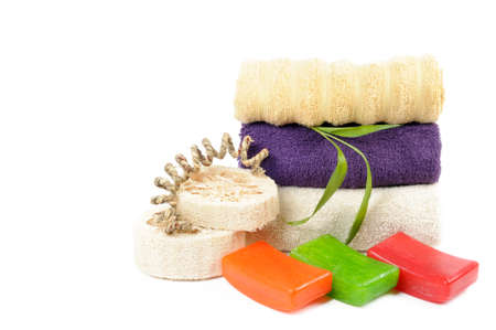 Spa or bathroom concept with towels and soaps, on a white backgroundの写真素材