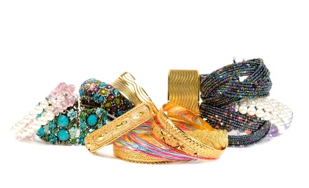 Stock of golden, gem and pearls bracelets ,  on a white background