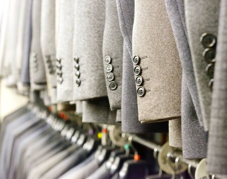 Fashion suits on hangers in the  show roomの写真素材