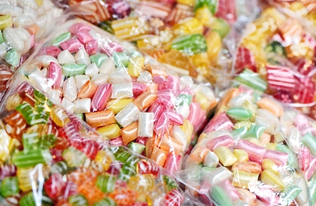Mixed colorful candies in the plastic bagsの写真素材
