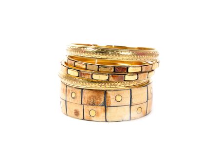 Golden bracelets set on a white background