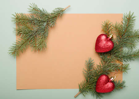 Christmas green framework background from pine tree branch and red hearts decor, close up.の写真素材