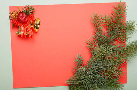Christmas red  background with pine branch and decor elements . Horizontal image with place for text.の写真素材