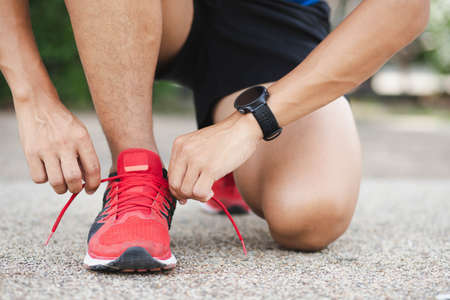 Close up of sportsman tying shoelace.Get ready to start exercising.healthy lifestyle concept.の写真素材