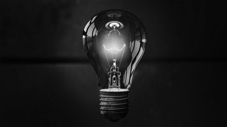 Glowing white light bulb on black. Idea concept with innovation and inspiration. Template Edison retro light bulb is glowing in the dark. Isolated on a transparent background.の写真素材