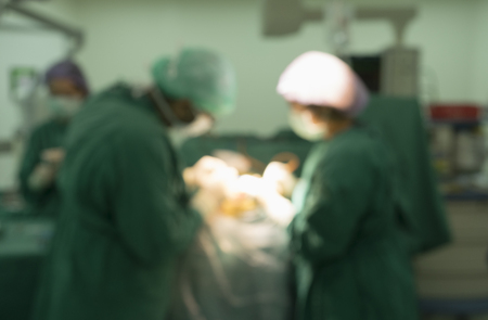 Blur image of operating room with neurosurgeon, assistant and nurse during neurosurgical procedureの写真素材