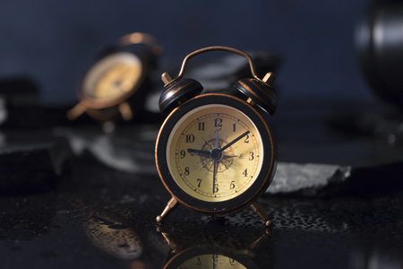 Two alarm clocks and reflectionsの写真素材