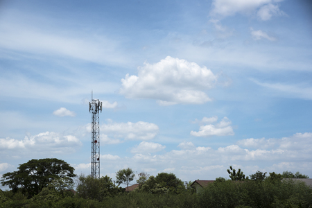 Telephone transmission tower in the village and blue skyの写真素材
