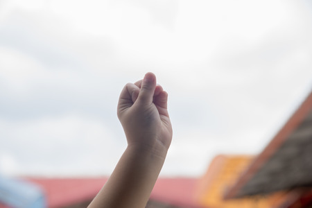 Raising a hand up in the air showing successの写真素材