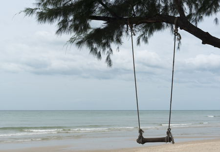 A swing made of wood on the beachの写真素材