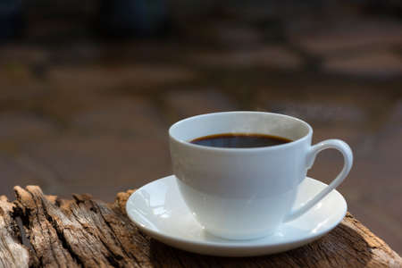 A white cup of coffee with smoke in the morning breakfastの写真素材