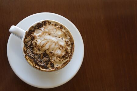 Top view of a tasty cappuccino coffee on the wooden tableの写真素材