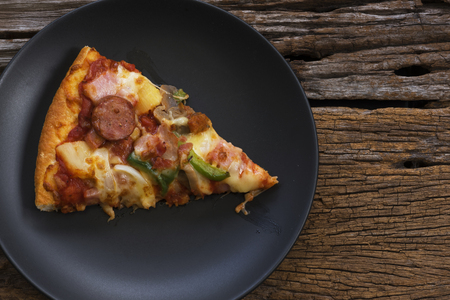 Top view of a piece of delicious pizza on a plateの写真素材