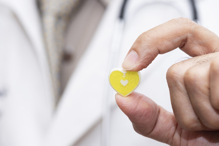 Doctor using finger to show a small green heart symbolの写真素材