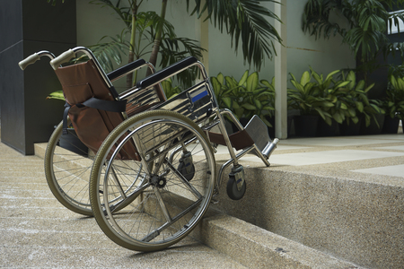 A brown wheelchair parking on the stairsの写真素材