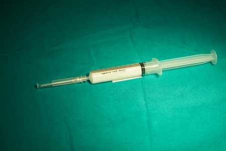 White color anesthetic drug in plastic syringe on the table in operating roomの写真素材