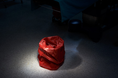 Empty red bin for garbage in the operating roomの写真素材