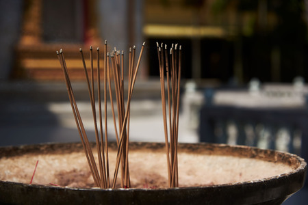 Joss-sticks and smoke in the pot for praying for the Buddha in Thai temple