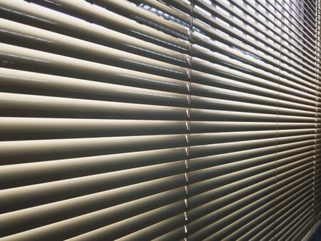 Pattern of indoor curtain in rows. Light and shadow in shade.の写真素材