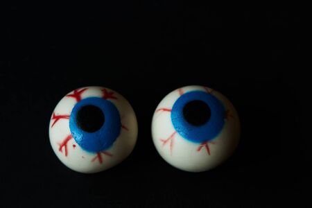 Two hallloween scary eyeballs on black backgroundの写真素材