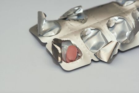 The last tablet of medicine in the medication silver colored panel on the table