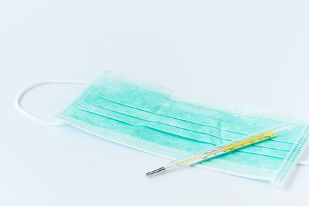 Concept of protecting virus infection by temperature measurement and wearing facial mask. An analog...