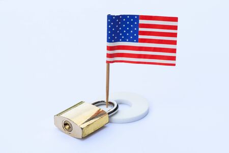 Concept of lockdown United States of America from corona viruses 2019 pandemic outbreak. USA flag and a key lock.の写真素材