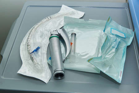 A set of anesthesiologist instruments includings laryngoscope, endotracheal tube, mouth gag and...
