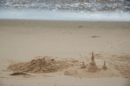 Forming beach sand as Buddhist temples on the beach. Using seashells to be towers.の写真素材