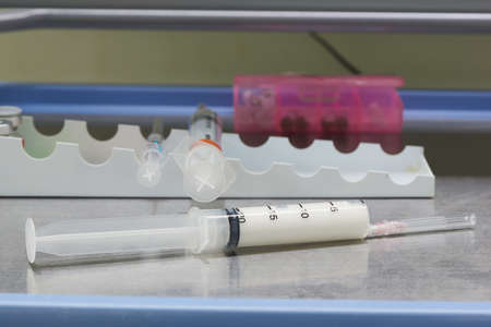 A white anesthetic drug in syringe on the table in operating room