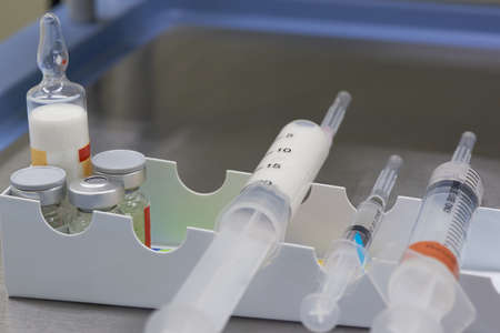 A white anesthetic drug in syringe and medications on the table in operating roomの写真素材