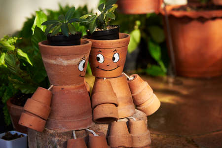 A pair of cute painted cactus pot   on the groundの写真素材