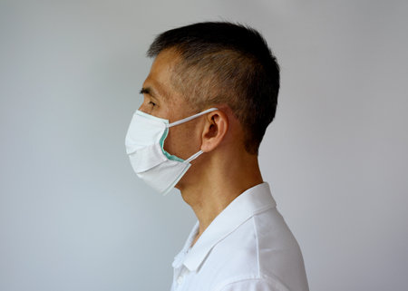 Asian senior adult man wearing double face mask, cloth mask and medical mask for highly covid-19...
