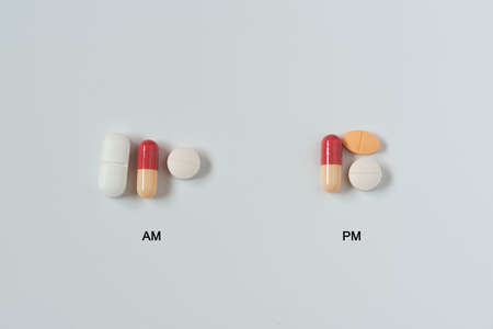 Medications on white background taking two times a day, in the morning and evening.の写真素材