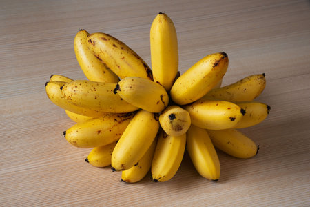 A bunch of delicious lady finger banana on the tableの写真素材