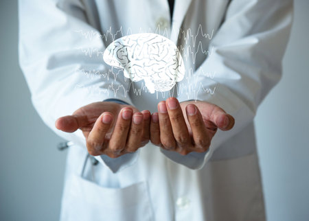 Doctor holding a brain model in his hands. Brain and brain waves illustration. Healthcare concept.の写真素材