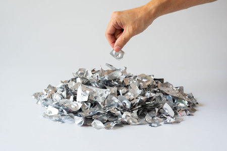 Orphan waste. Hand Disposing of Medicine Blister  on Pile of Pharmaceutical Blister Pack Wasteの写真素材