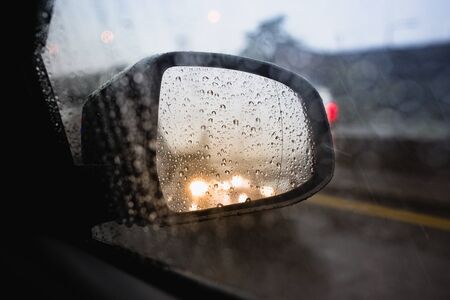 The rain and reflection in mirror and traffice jam in bangkok thailandの写真素材