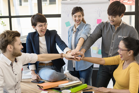 Group of Diverse happy business team in casual style Hands Together Joining.Office Team,Business...