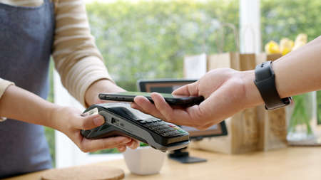 Close-up hand asia woman people work in small sme coffee cafe shop store owner use cashless wifi qr...