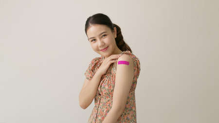 Young attractive beautiful asia female or teenage receive covid-19 anti virus vaccine in campaign...
